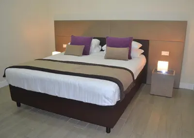a bedroom with a large bed with purple pillows at Bloom Apartment in Rome
