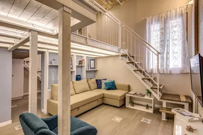 a living room with a couch and a staircase at Domus Urbana in Rome