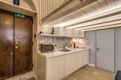 a kitchen with a sink and a microwave at Domus Urbana in Rome