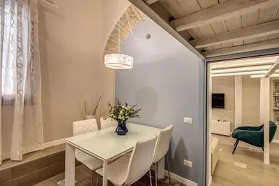 a dining room with a white table and chairs at Domus Urbana in Rome