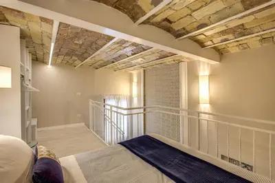 a bedroom with a bed and a staircase in a room at Domus Urbana in Rome
