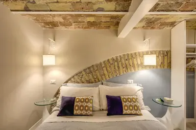 a bedroom with a bed with two glass tables at Domus Urbana in Rome