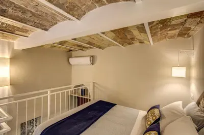 a bedroom with a bed and a brick ceiling at Domus Urbana in Rome