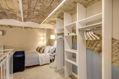 a bedroom with a bed in a room with a stone ceiling at Domus Urbana in Rome