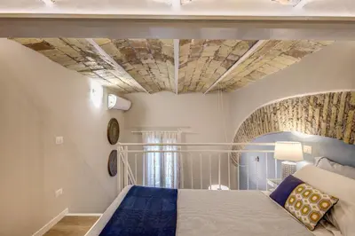 a bedroom with a bed with a stone ceiling at Domus Urbana in Rome