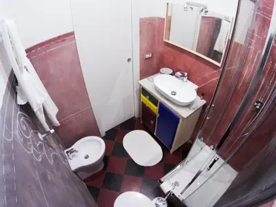 a bathroom with two toilets and a sink and a mirror at L'architetto in Rome