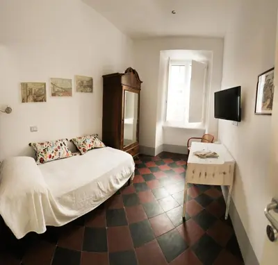 a bedroom with a bed and a table and a mirror at L'architetto in Rome