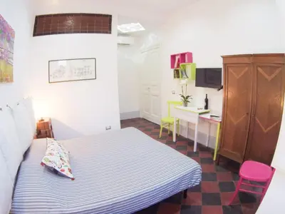 a small room with a bed and a desk and a table at L'architetto in Rome