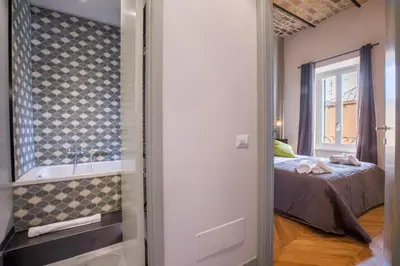 a bedroom with a bed with towels on it at EVE Penthouse Colosseo in Rome