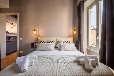 a bedroom with a bed and a living room at EVE Penthouse Colosseo in Rome