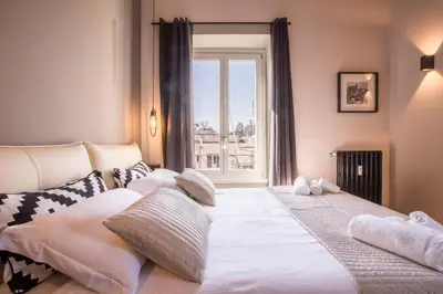 a living room with a couch and a table at EVE Penthouse Colosseo in Rome