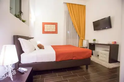 a hotel room with a bed and a television at Bbqueen in Rome
