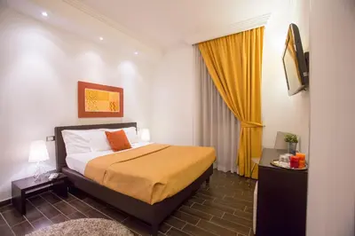 a bedroom with a bed and a yellow curtain at Bbqueen in Rome