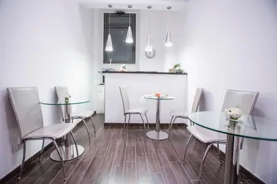 a dining room with two glass tables and chairs at Bbqueen in Rome