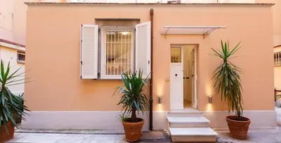 a house with two palm trees in front of it at Parioli House near Borghese-LUISS University in Rome