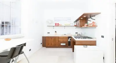 a kitchen with wooden cabinets and a stove at Parioli House near Borghese-LUISS University in Rome