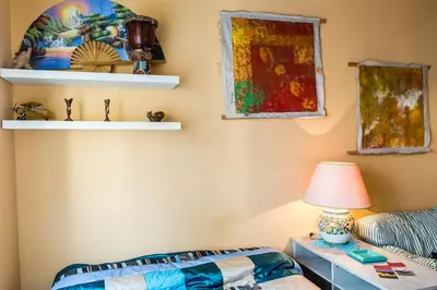 a living room with a table and a lamp at La Casetta Di Tiziana in Rome