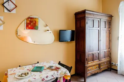 a dining room with a table and a mirror at La Casetta Di Tiziana in Rome