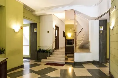 a hallway with stairs in a building with green walls at La Casetta Di Tiziana in Rome