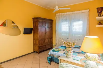 a bedroom with a bed and a dresser and a window at La Casetta Di Tiziana in Rome