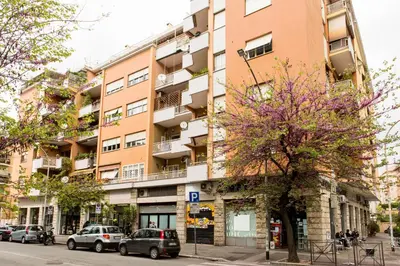 an apartment building on a street with parked cars at La Casetta Di Tiziana in Rome