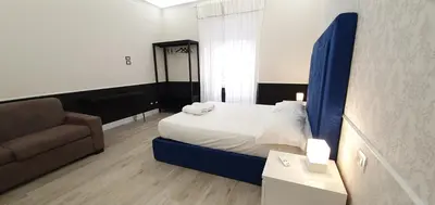 a bedroom with a bed and a couch and a chair at Rome Aparts in Rome