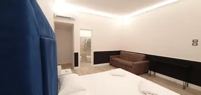 a room with a bed and a couch and a chair at Rome Aparts in Rome