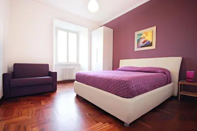 a bedroom with a bed and a chair at Rome Aparts in Rome