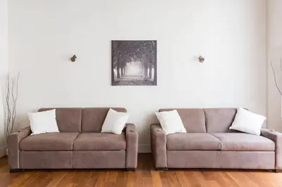 a living room with two couches and a picture on the wall at Campo Marzio Boutique in Rome