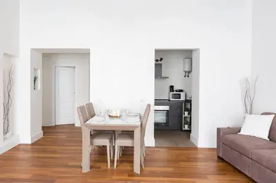 a dining room with a table and a couch at Campo Marzio Boutique in Rome