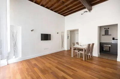 a dining room with a table and a kitchen at Campo Marzio Boutique in Rome