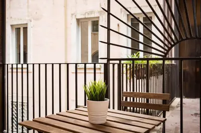 a wooden bench with plants on a balcony at Campo Marzio Boutique in Rome