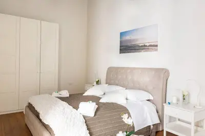 a bedroom with a bed with white sheets and pillows at Campo Marzio Boutique in Rome
