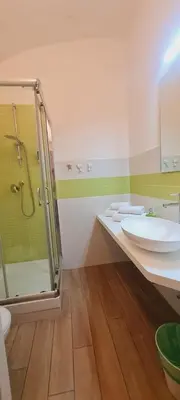 a bathroom with a sink and a shower and a toilet at Bed&BikeRome ROOMS in Rome