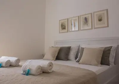 a white bed with towels on top of it at Splendid House In Trastevere in Rome