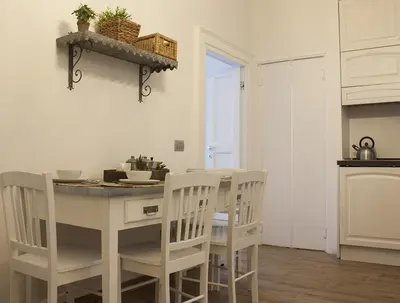 a kitchen and dining room with a table and chairs at Splendid House In Trastevere in Rome