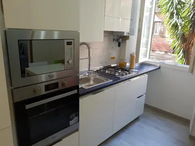 a kitchen with a sink and a stove top oven at Suite Luisa Roma in Rome