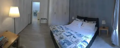 a bedroom with a bed and a table and a lamp at Suite Luisa Roma in Rome