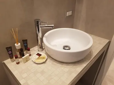 a white sink sitting on a counter in a bathroom at Suite Luisa Roma in Rome