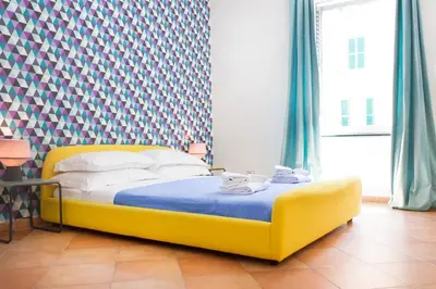 a bedroom with a yellow bed in a room at TrastevereHome - Vespucci Rome Testaccio Home in Rome
