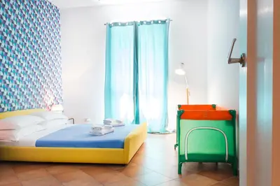 a bedroom with a bed with a blue and yellow at TrastevereHome - Vespucci Rome Testaccio Home in Rome