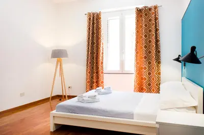 a bedroom with a bed and a window at TrastevereHome - Vespucci Rome Testaccio Home in Rome