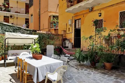 a patio with a table and chairs and a building at Pretty Flat Trastevere in Rome