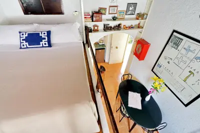 a small bedroom with a bed and a chair at Pretty Flat Trastevere in Rome