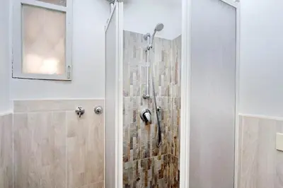 a shower with a glass door in a bathroom at Pretty Flat Trastevere in Rome