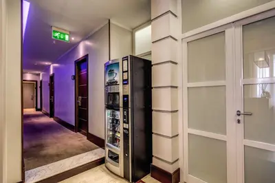 a walk in wine cellar with a glass door at Hotel Giuggioli in Rome