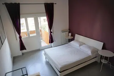 a small bedroom with a bed and a window at Rhome Away Marconi in Rome