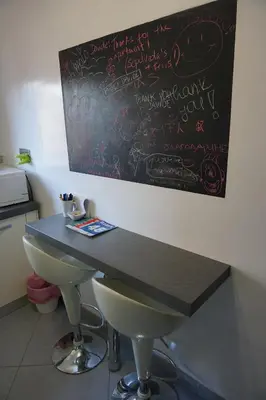a table in a kitchen with writing on the wall at Rhome Away Marconi in Rome