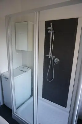a shower with a glass door next to a toilet at Rhome Away Marconi in Rome