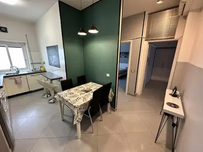 a kitchen and dining room with a table and chairs at Rhome Away Marconi in Rome